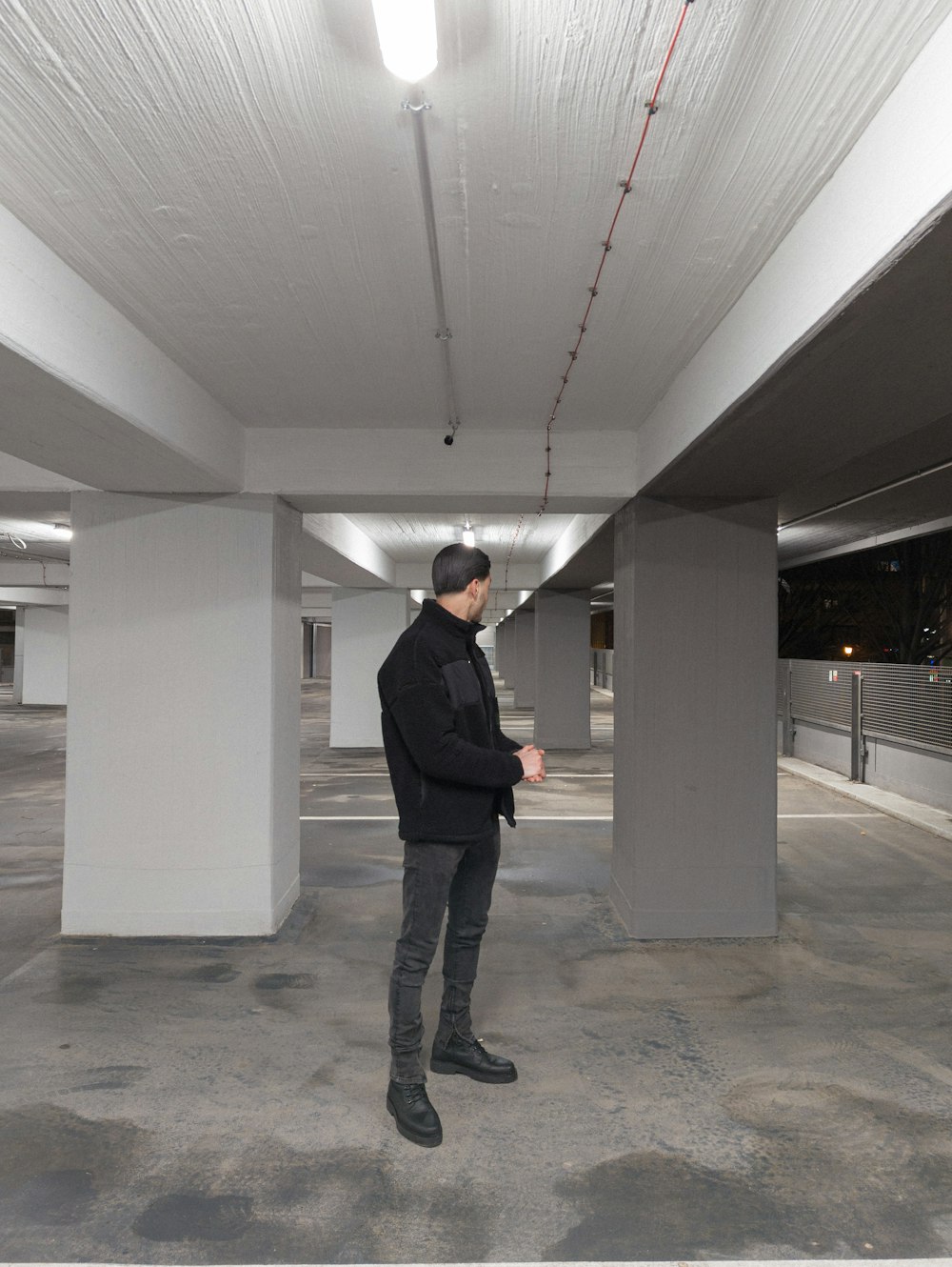 a man standing in an empty parking garage