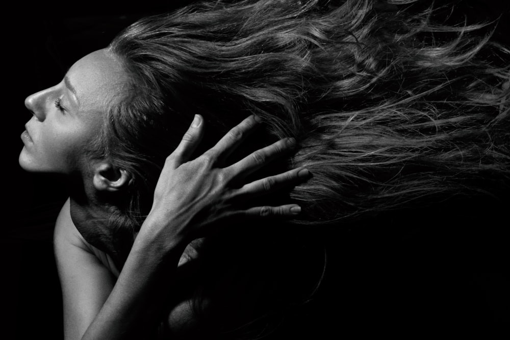 a woman with her hair blowing in the wind