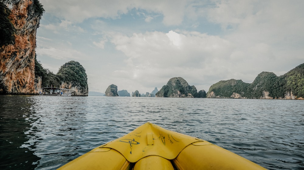 a yellow kayak in the middle of a body of water