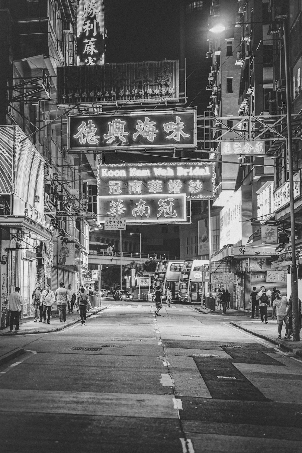 a black and white photo of a city street at night