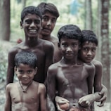 a group of young boys standing next to each other