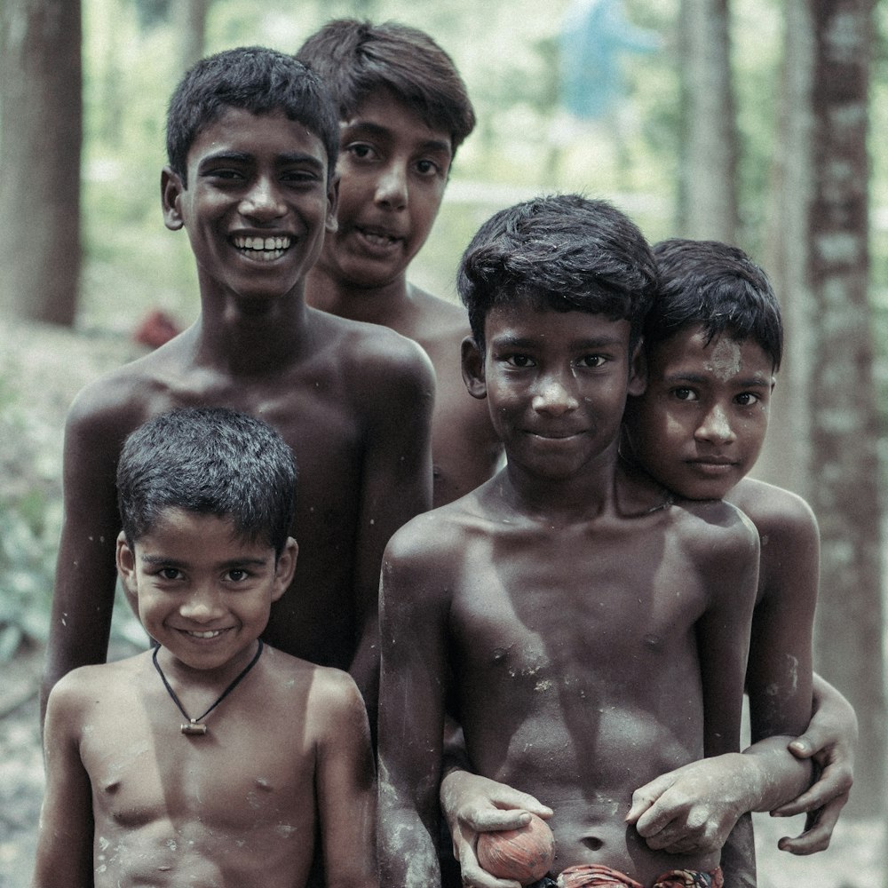 a group of young boys standing next to each other