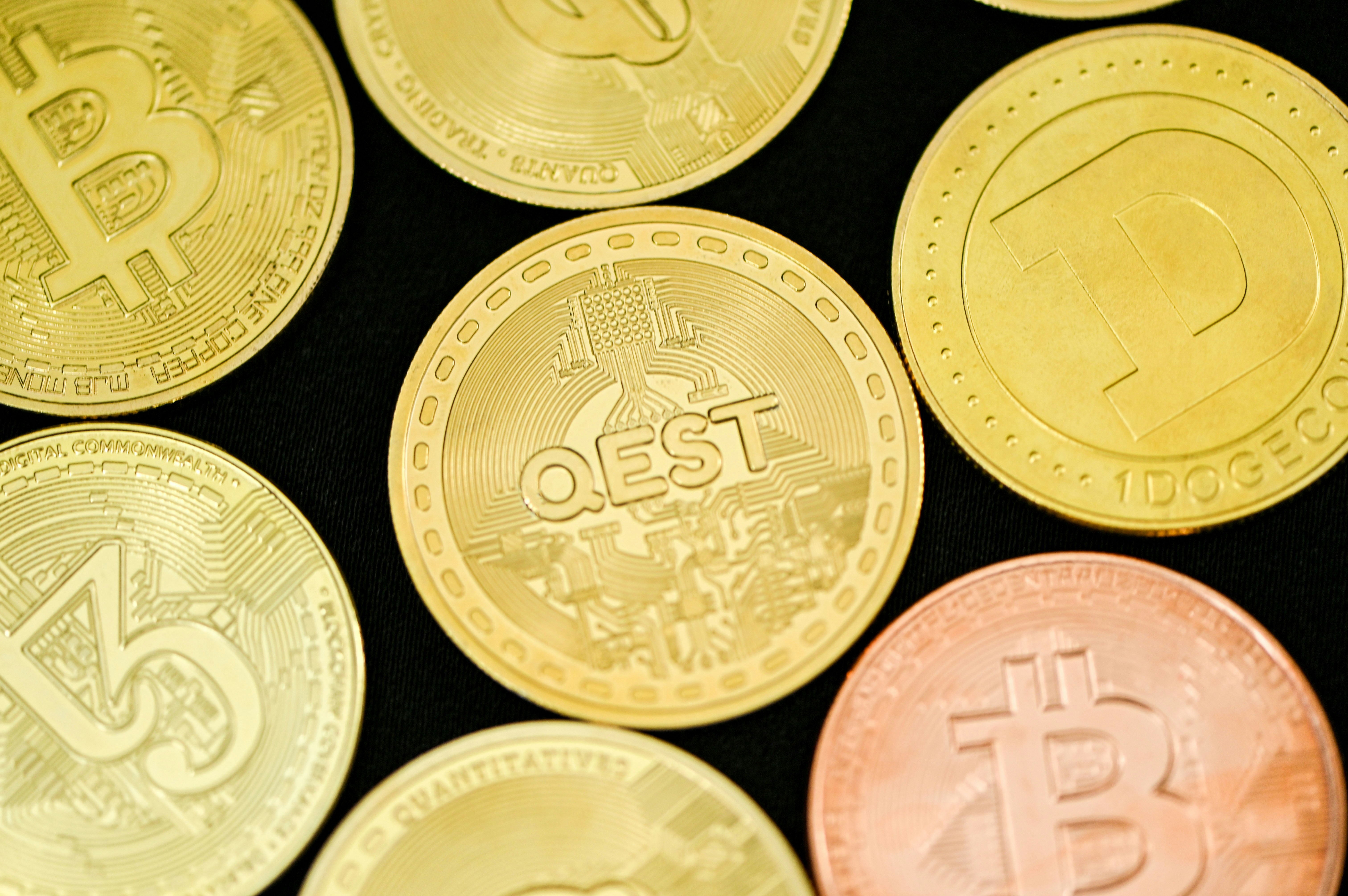 QEST coin surrounded by other cryptocurrency coins