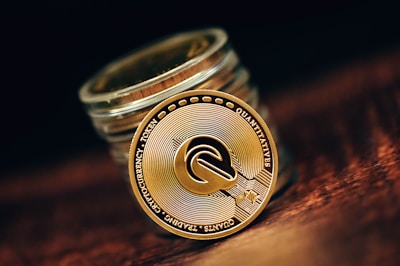 a stack of coins sitting on top of a wooden table
