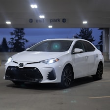 a white car parked in a parking lot