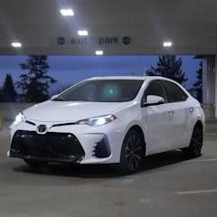a white car parked in a parking lot