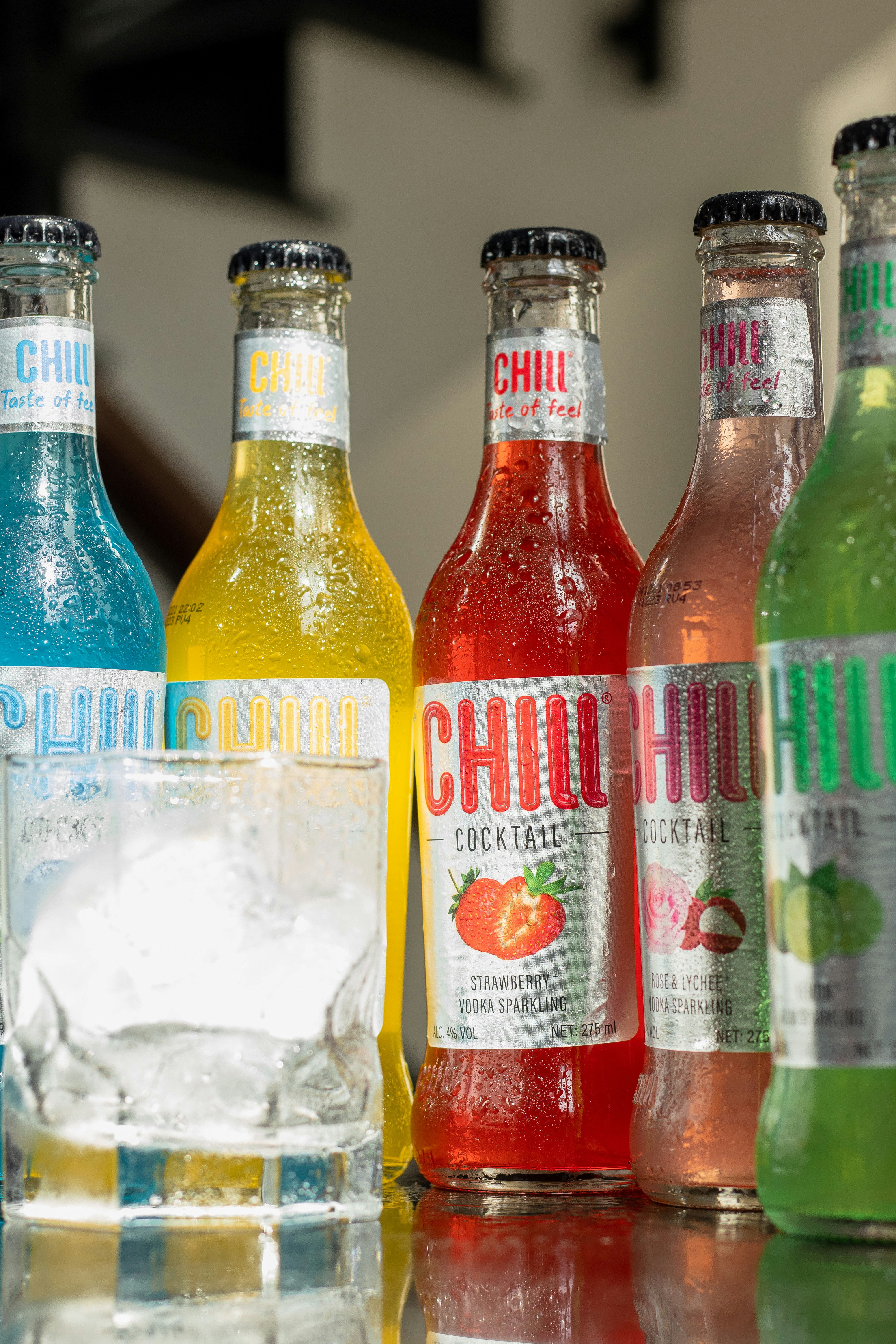 a group of bottles of different flavored beverages