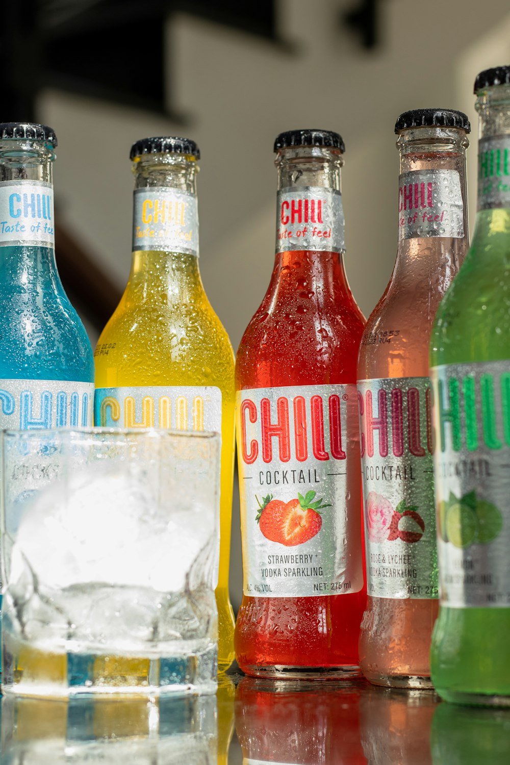 a group of bottles of different flavored beverages