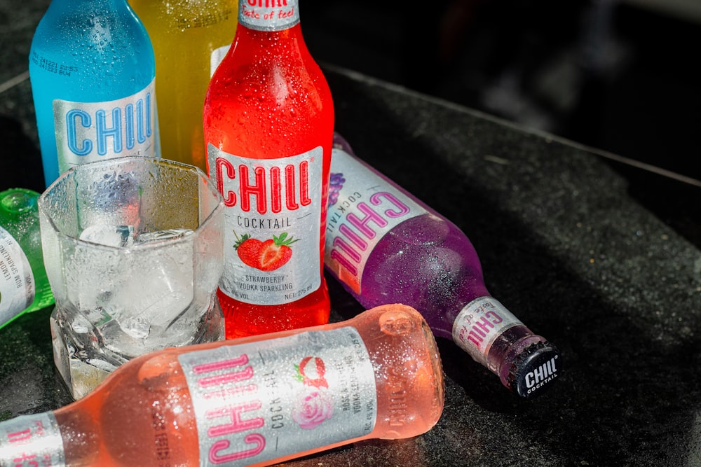 a table topped with bottles of different types of drinks