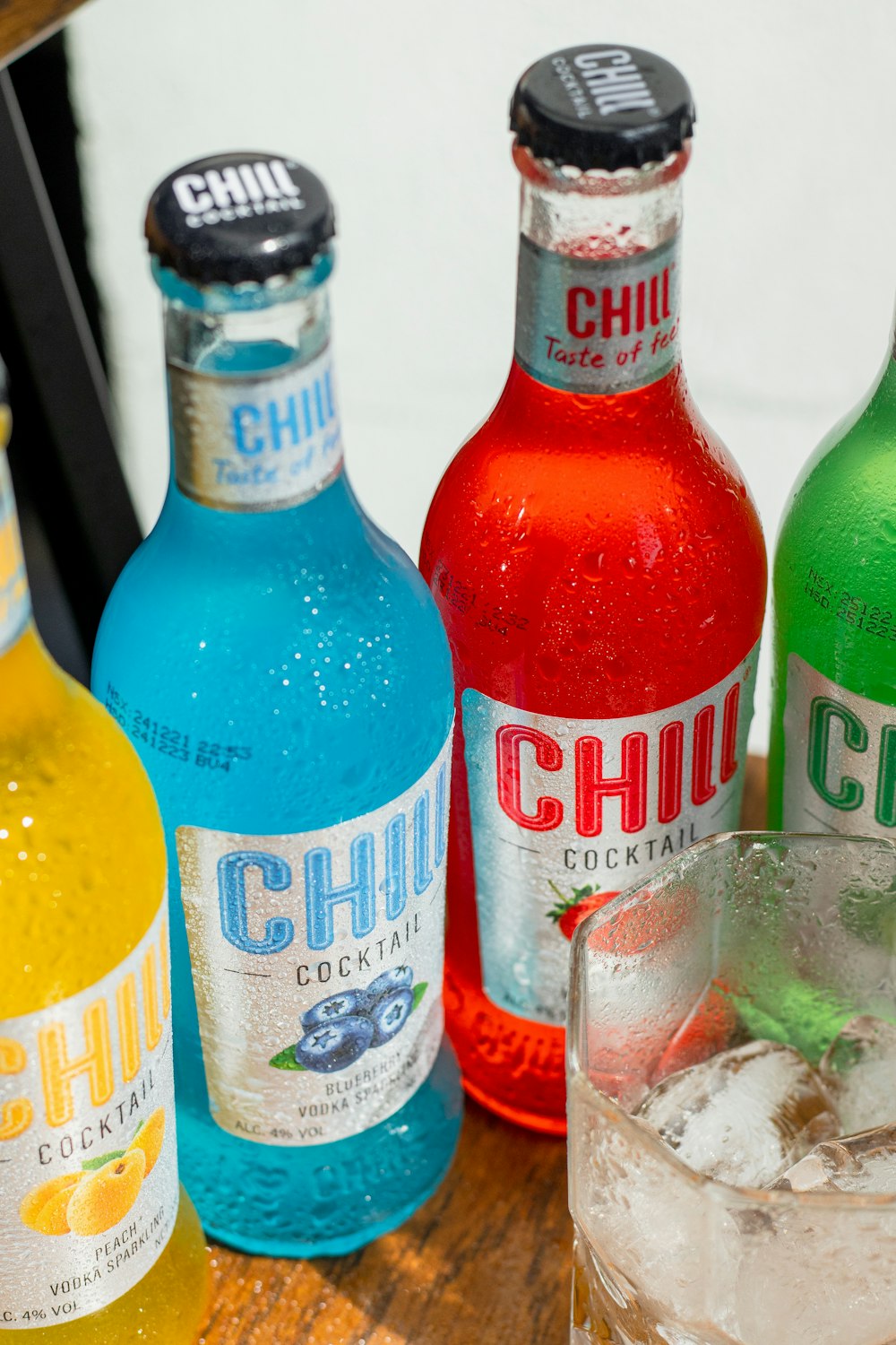 a group of bottles of alcohol sitting on top of a wooden table