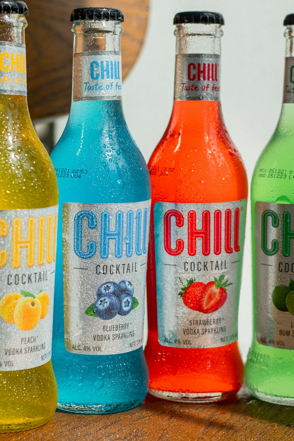 a group of bottles of different flavored drinks