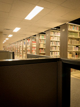 a row of bookshelves in a library filled with lots of books