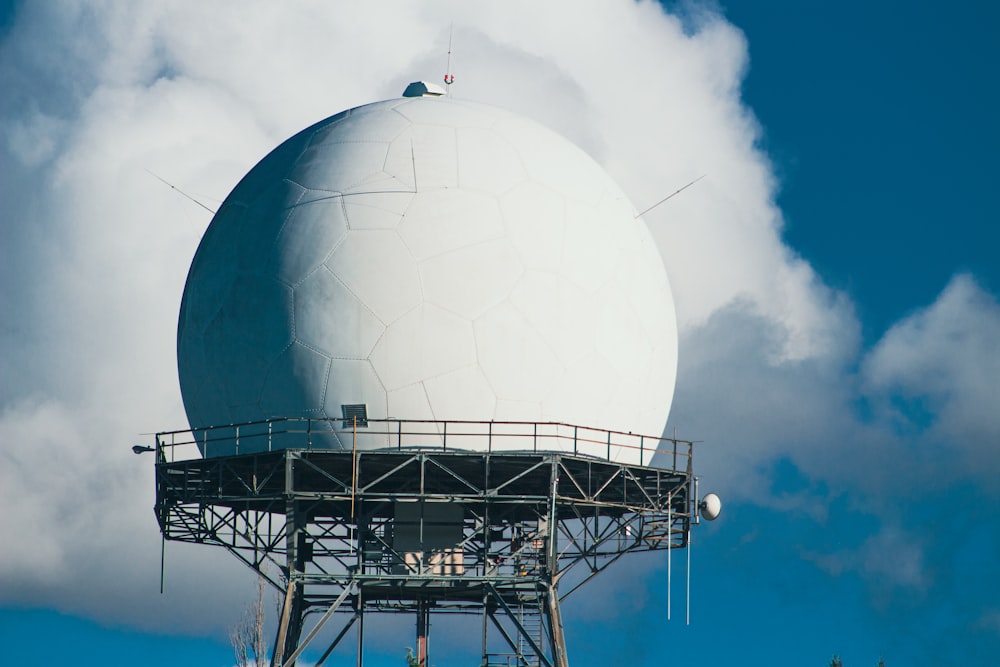 a large white ball sitting on top of a metal structure