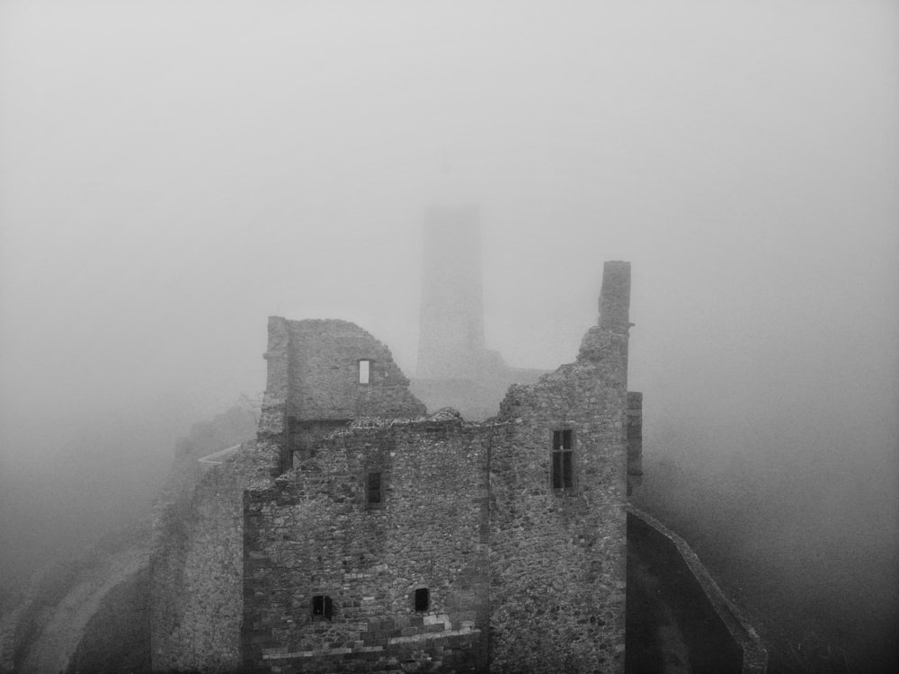 a castle in the middle of a foggy day