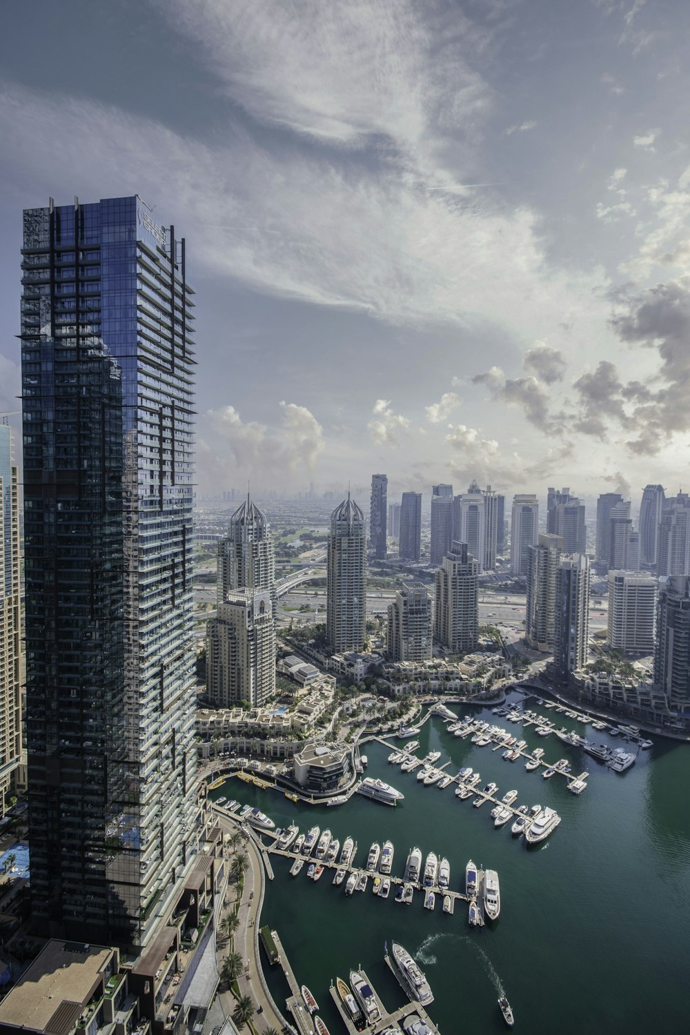 an aerial view of a city with boats in the water