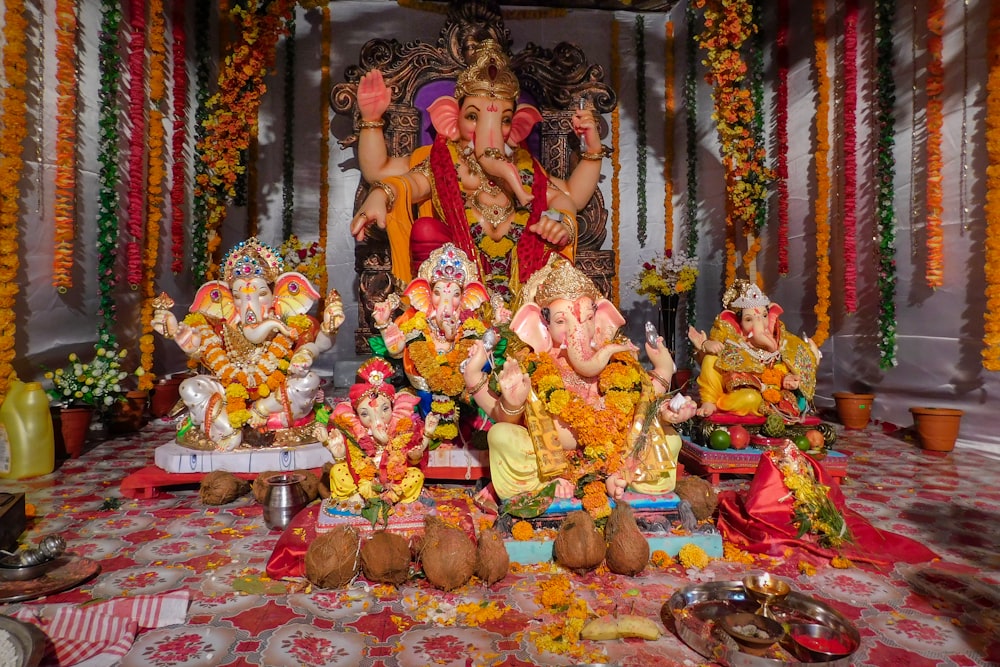 a group of statues of hindu deities in a room