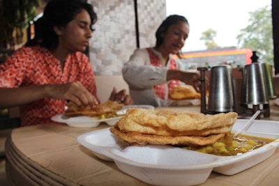 A satisfied customer enjoying a tiffin meal.