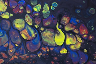 Abstract artwork featuring various fluid shapes and vibrant colors such as neon yellow, blue, red, and orange, forming intricate and organic patterns against a dark background.