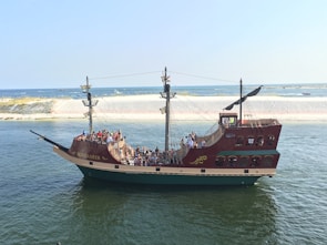 a large boat filled with people on a body of water