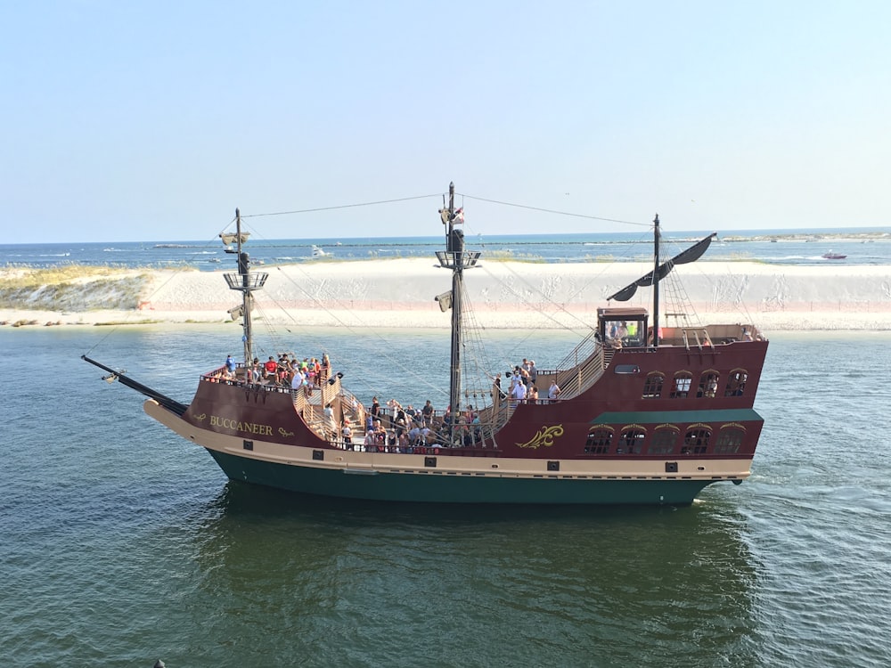 a large boat filled with people on a body of water