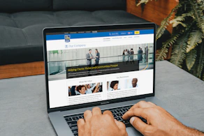 a man using a laptop computer on a table