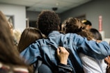 a group of people looking at a cell phone