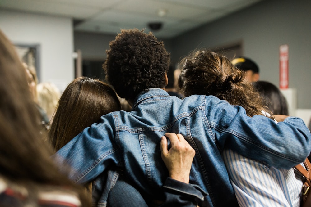 a group of people looking at a cell phone