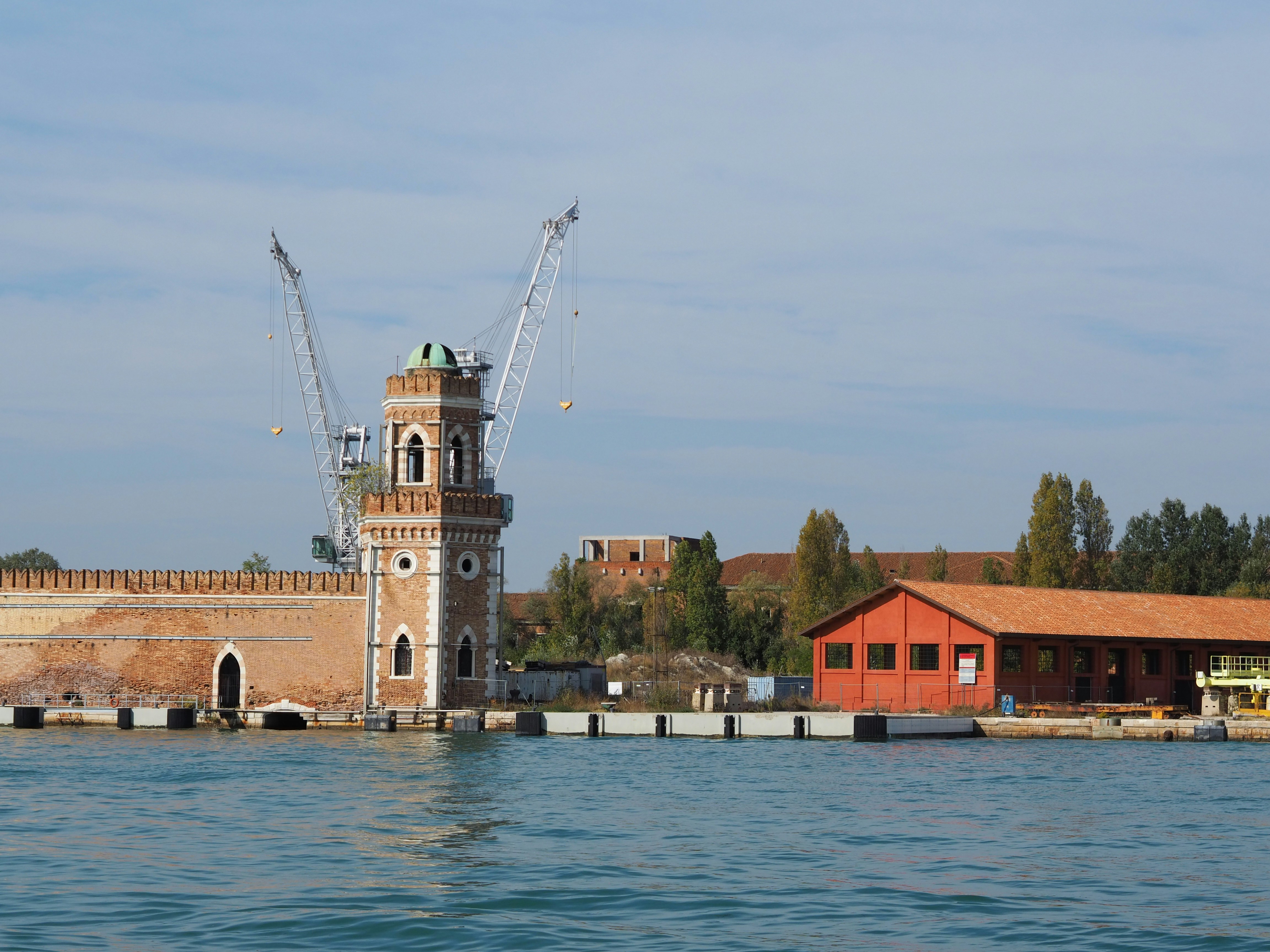 a large body of water with a clock tower in the background
