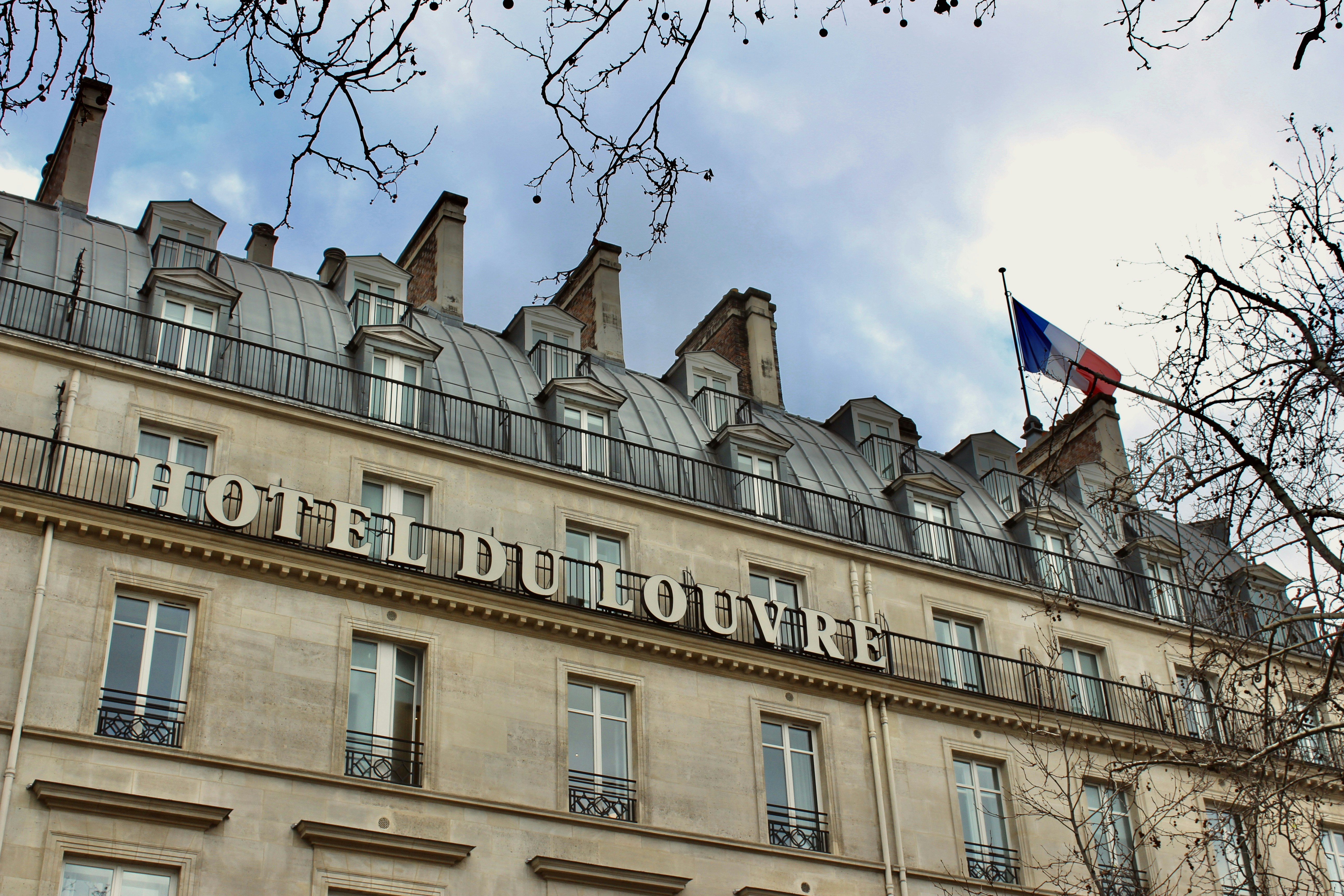 a tall building with a flag on top of it