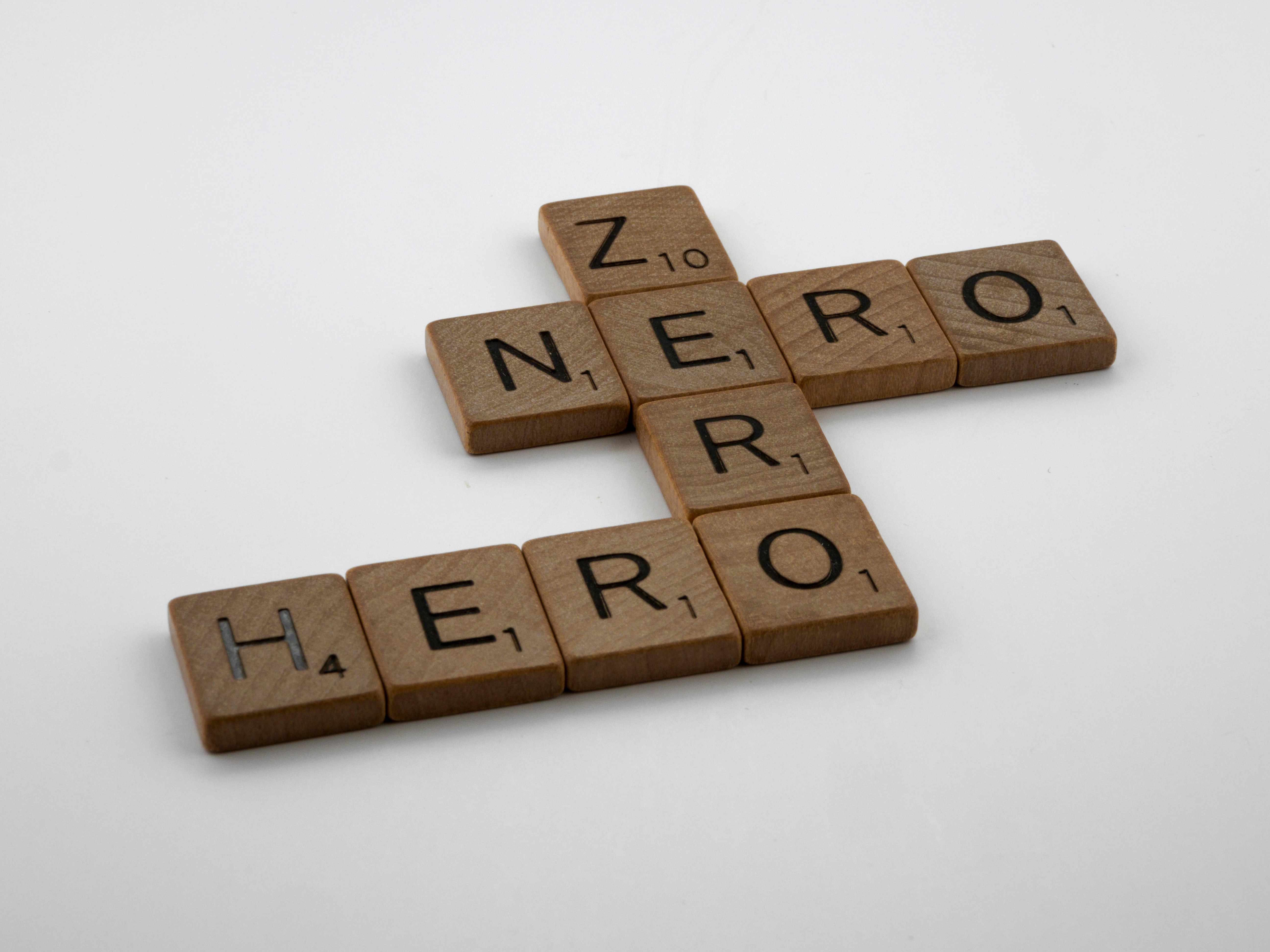 a cross made of scrabble tiles spelling zero hero