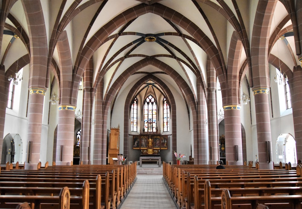 the inside of a church with rows of pews