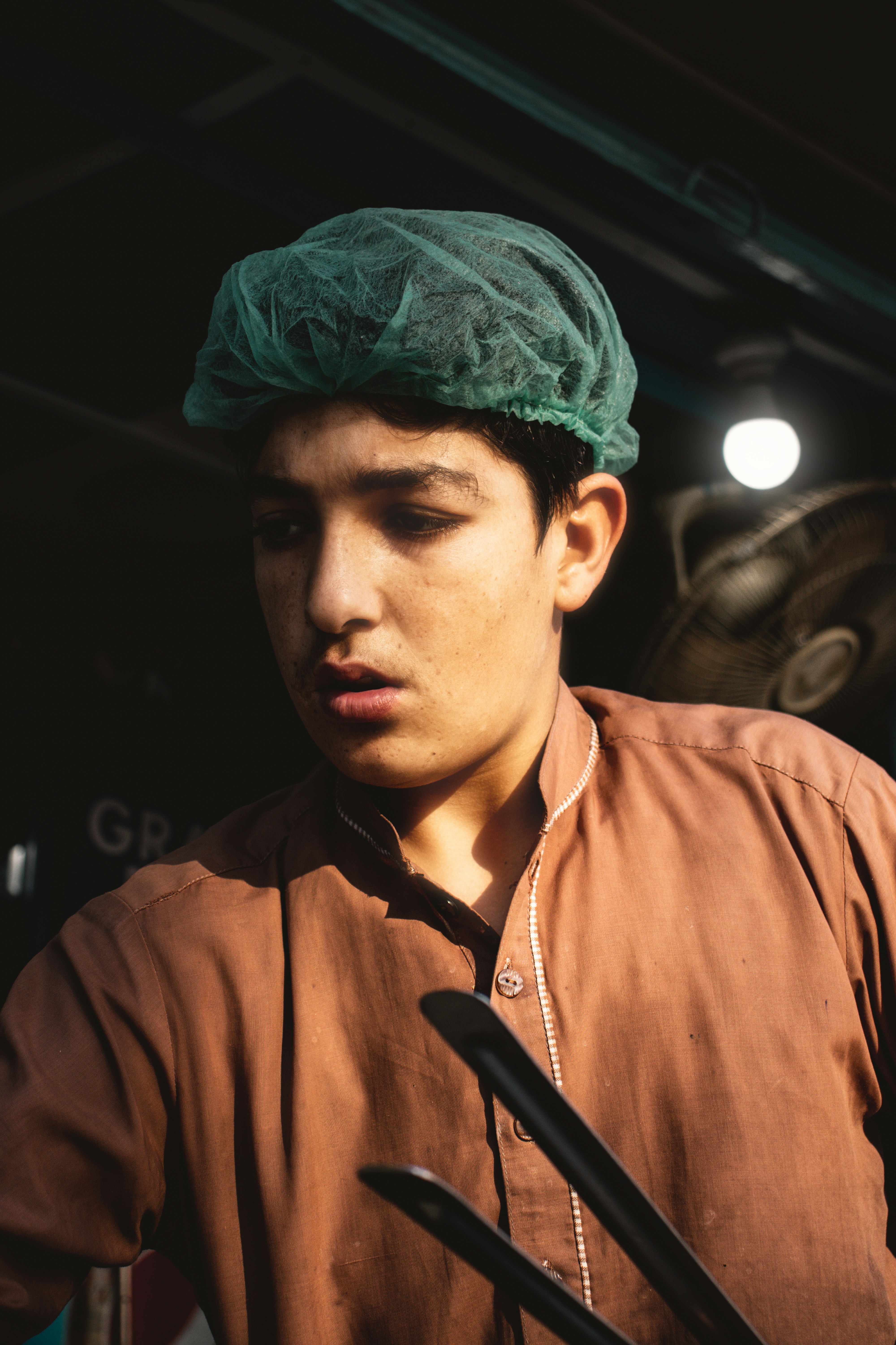 a man wearing a green hat and holding a microphone