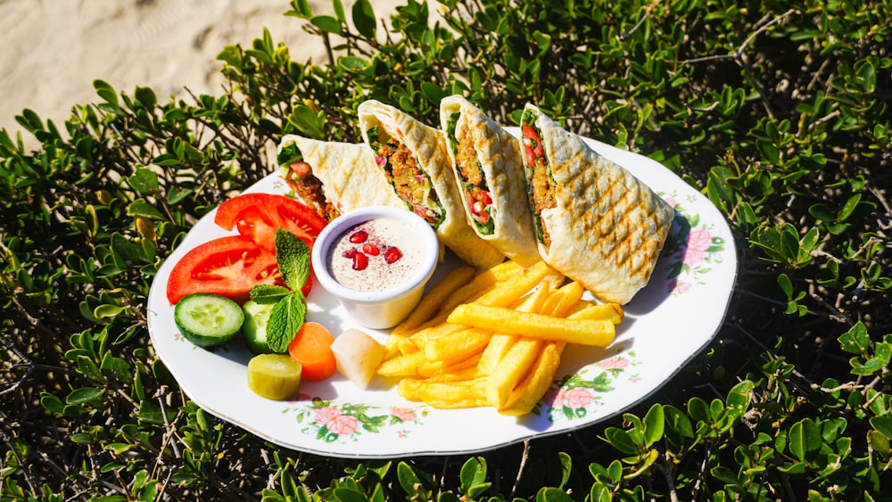 a white plate topped with a sandwich and french fries