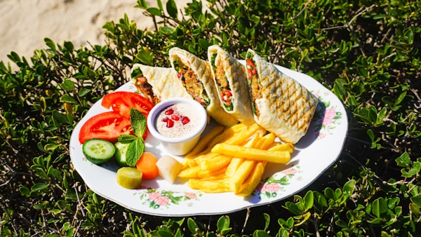 A white plate topped with a sandwich and french fries