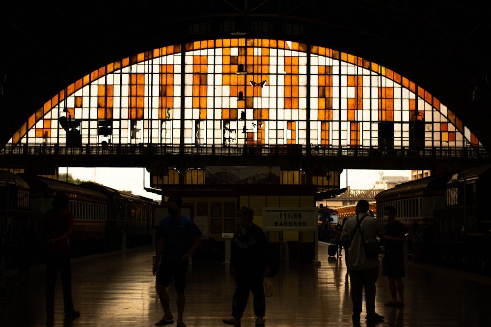 a group of people standing in a train station