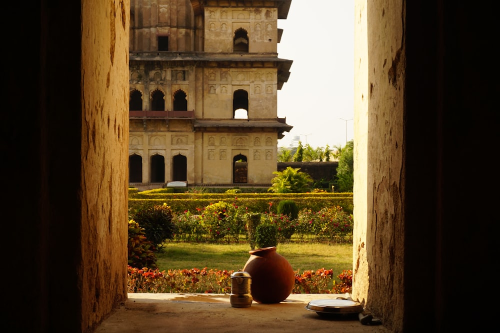 a vase sitting on the ground in front of a building