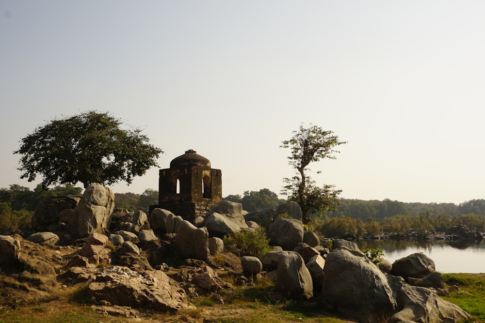 a stone structure sitting on top of a lush green field