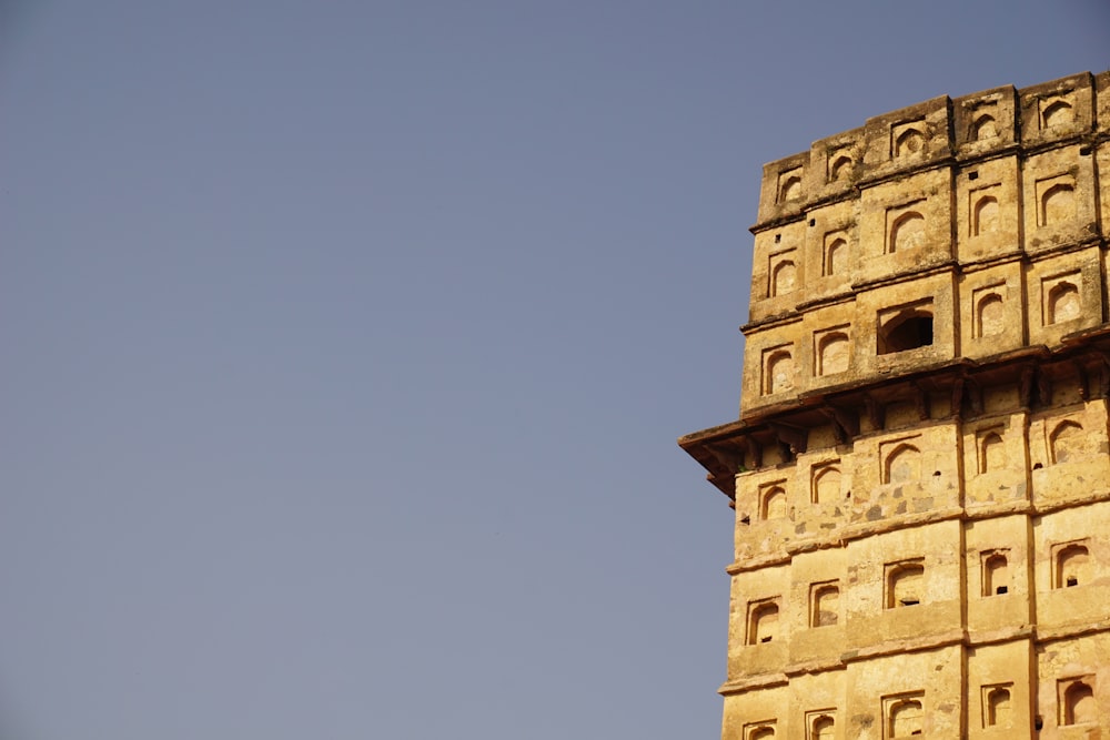 a very tall tower with a clock on it's side