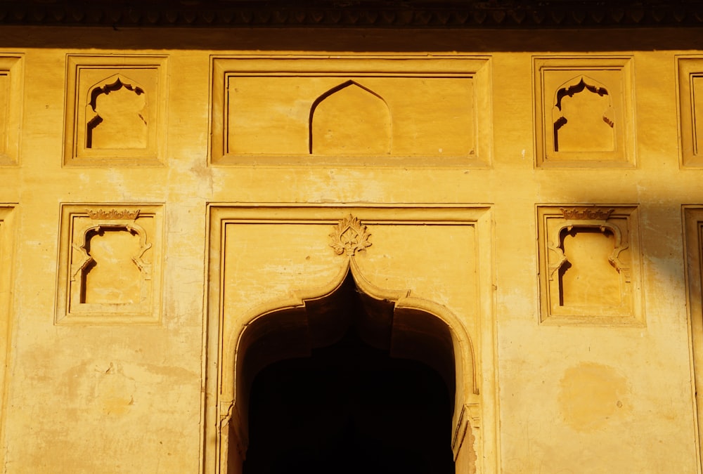 a yellow building with a door and a window