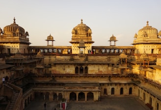 a large building with a lot of pillars and domes on top of it