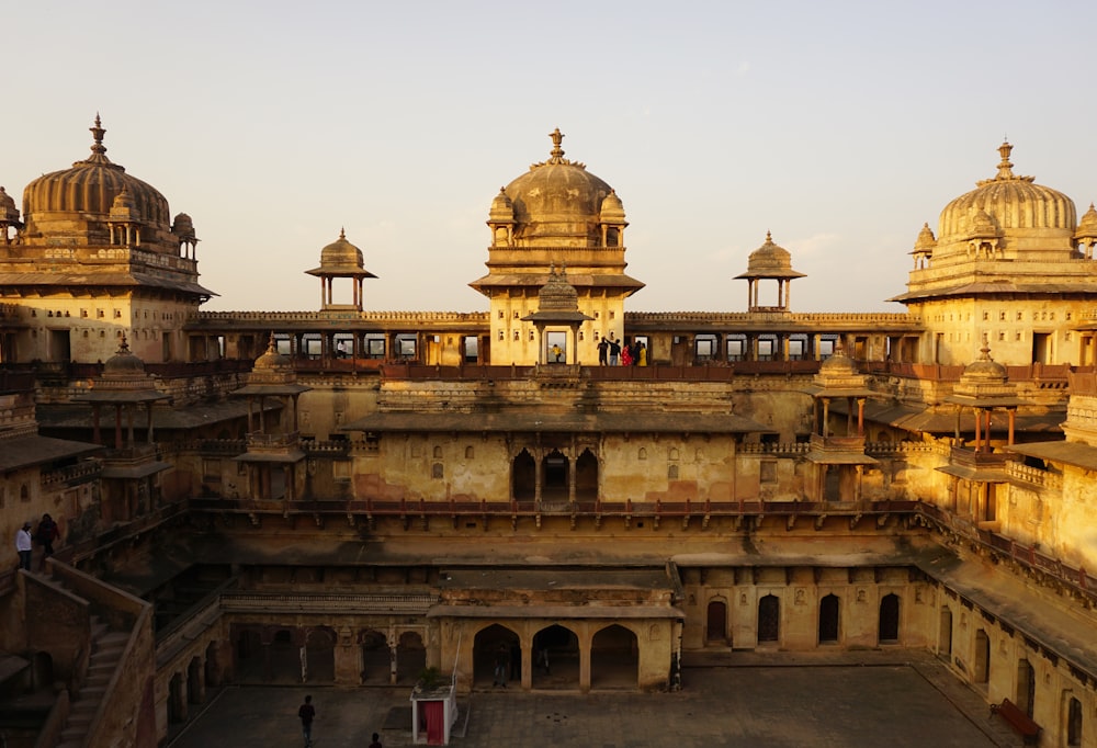 a large building with a lot of pillars and domes on top of it