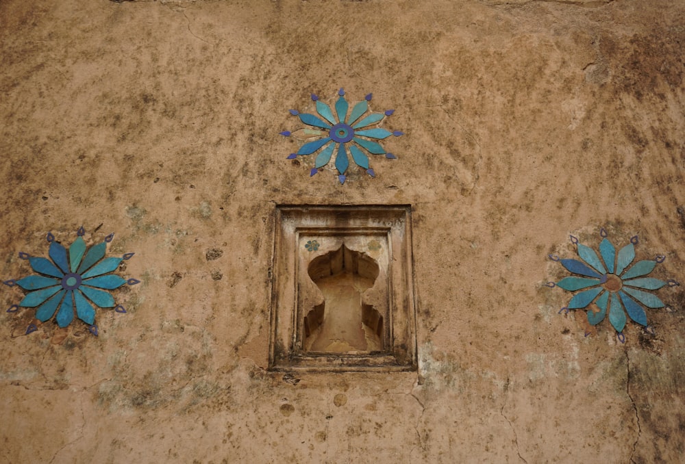 a wall with blue flowers painted on it