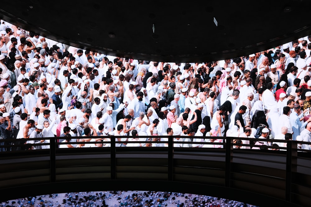 a large group of people standing in front of a large screen