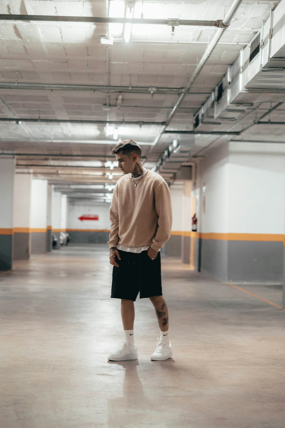 a man standing in an empty parking garage