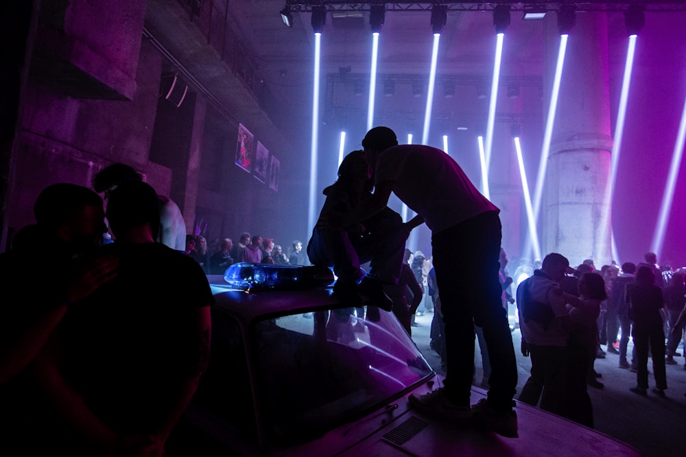 a group of people standing around in a dark room