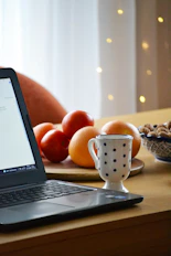 a laptop computer sitting on top of a wooden table