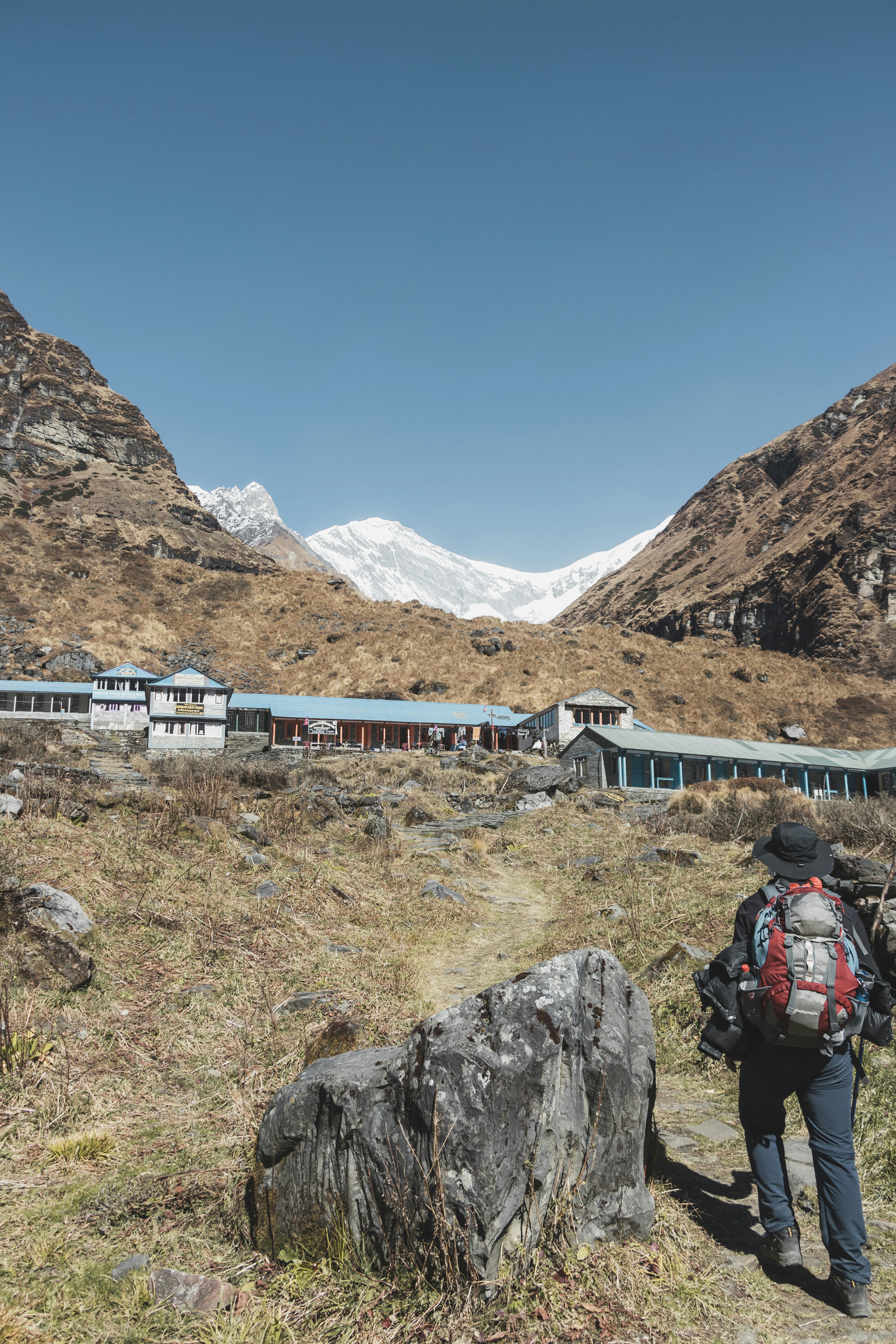 a person with a backpack walking up a hill