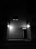 Evening shot of a well-lit facade highlighting minimalist design.
