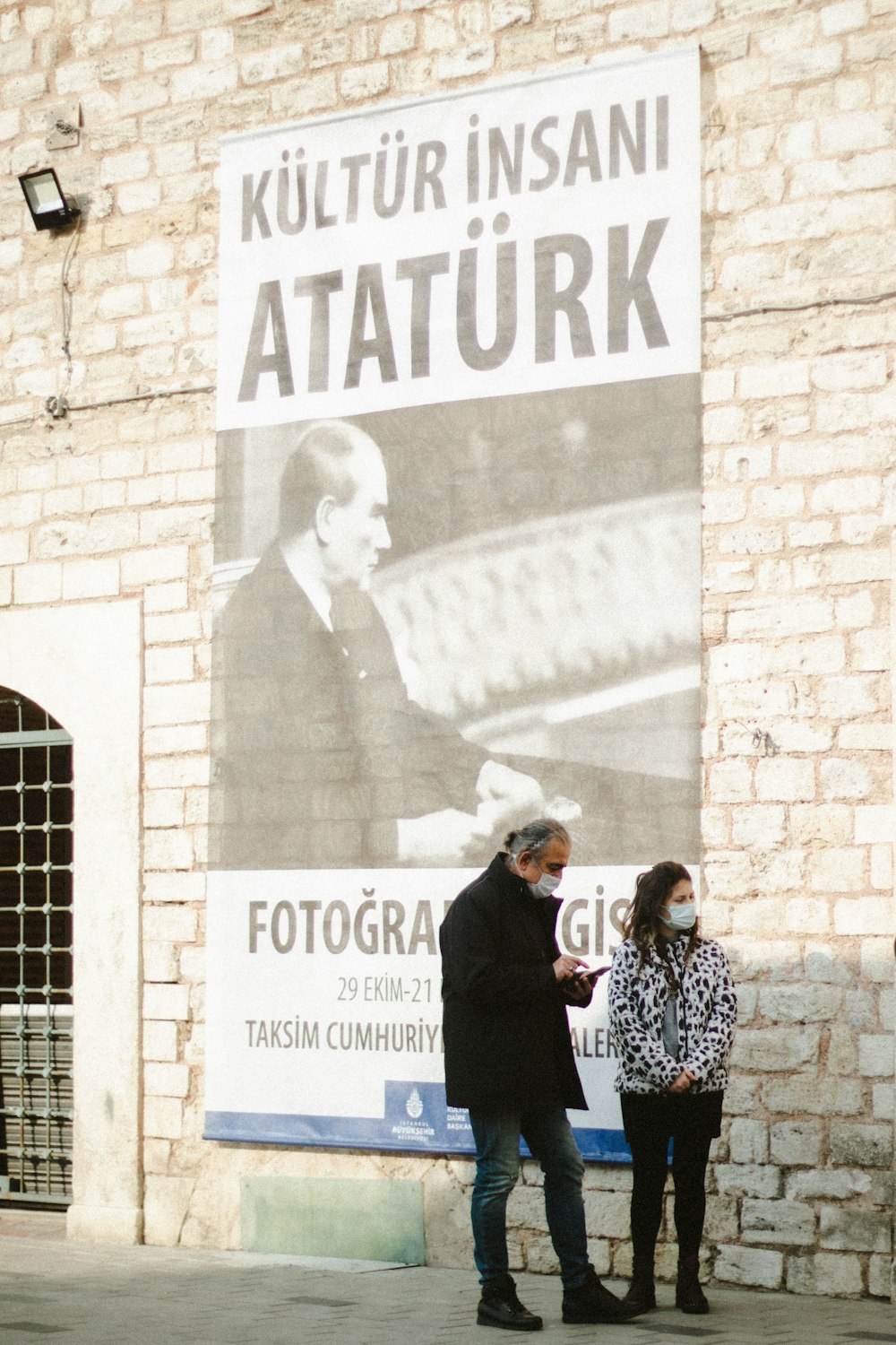 a man and a woman standing in front of a building