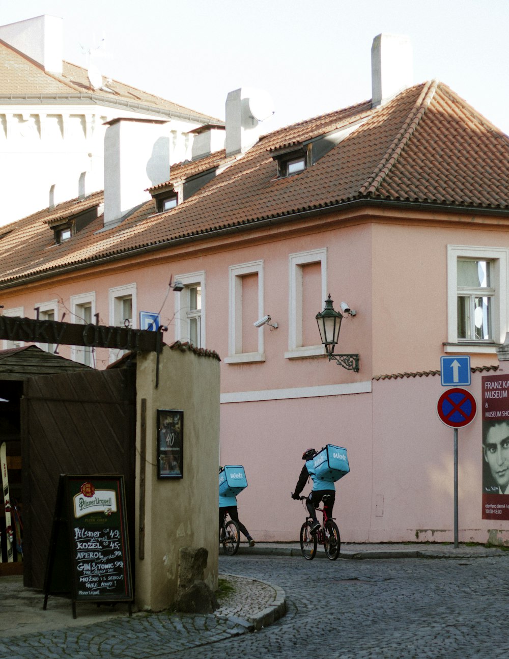 a couple of people riding bikes down a street